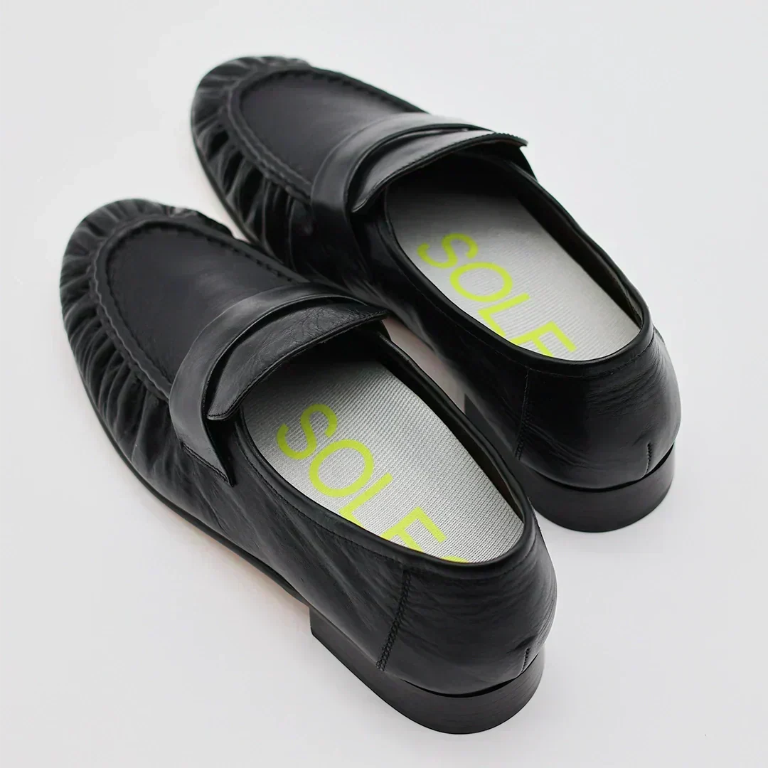 A close up photo of loafers with SOLE5 Half Length Orthotic Insoles fitted inside for standing all day at work