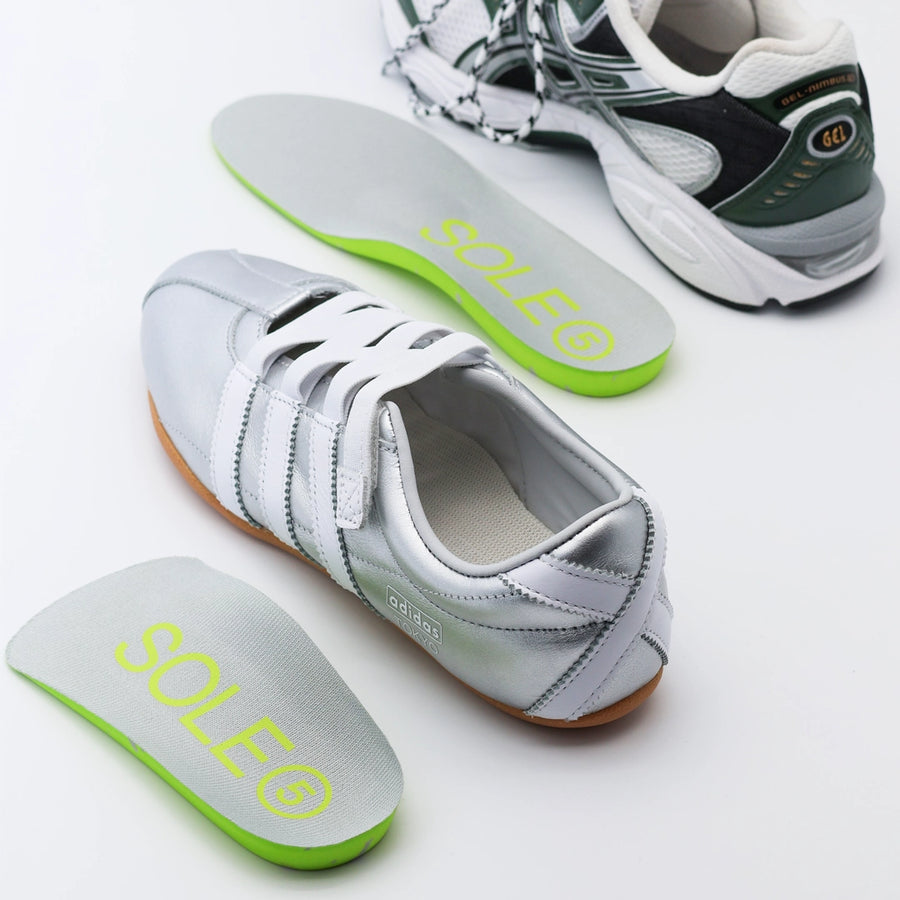 Silver casual shoe and green athletic shoe with a SOLE5 Full  Length & Half Length Orthotic Insole placed next to them.