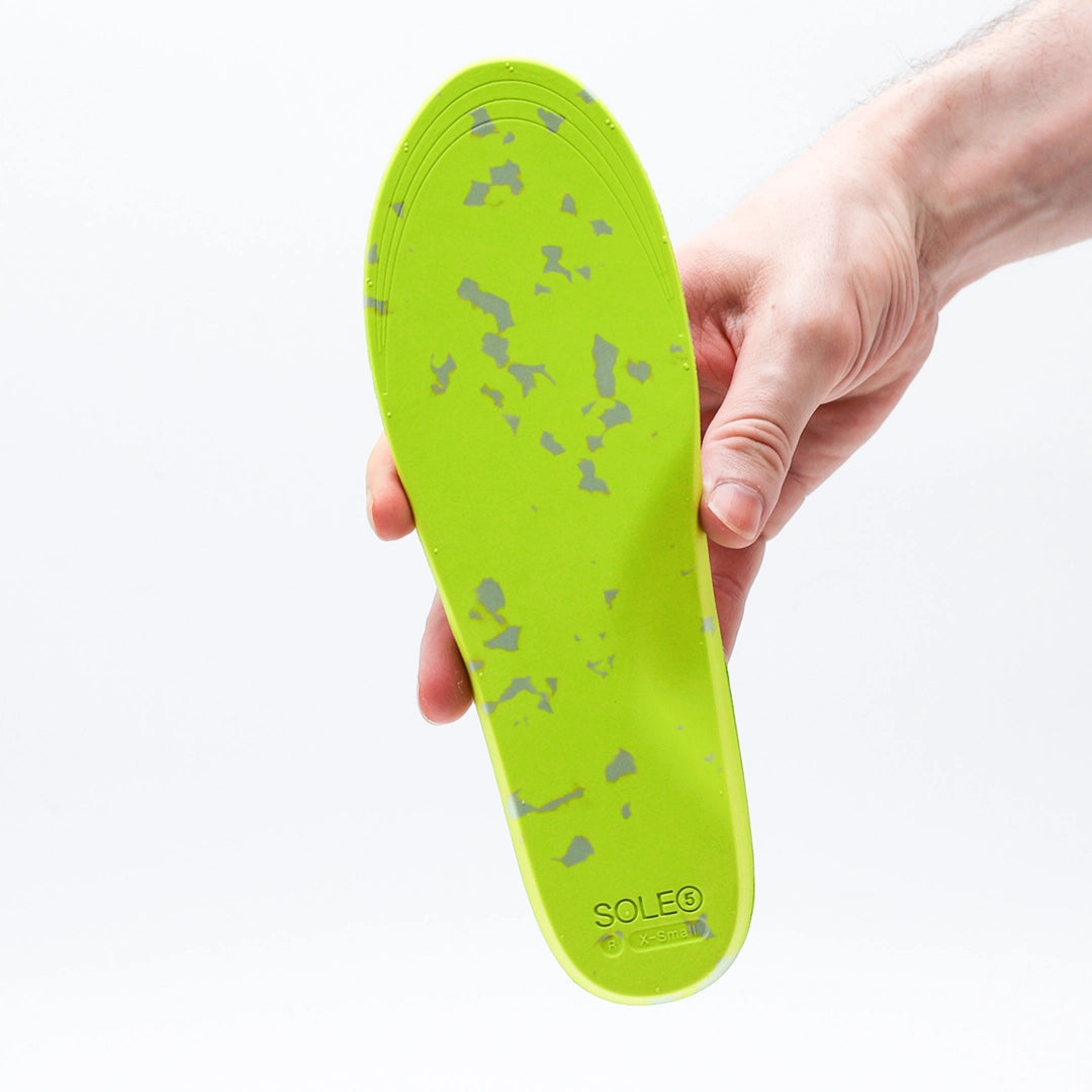 Underneath of a SOLE5 Full Length Orthotic Insole. highlighting the fluroscent green and grey materials
