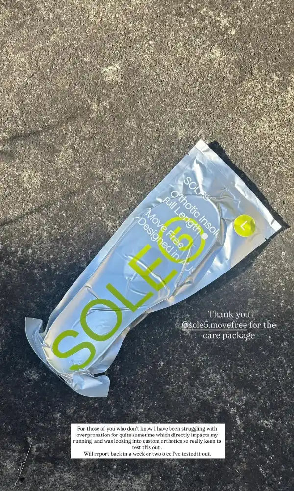 A matte silver vacuum sealed SOLE5 Full Length packaging, featuring fluorescent green branding, lying on a dark asphalt surface. The text is thanking SOLE5 for their products that help with the users overpronation issues.