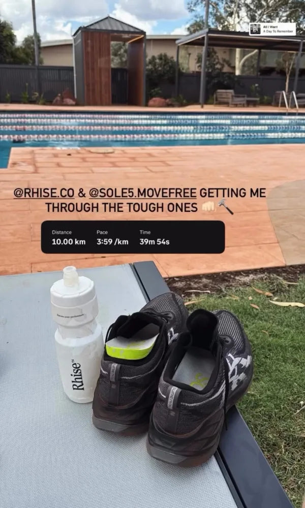 A pair of black athletic shoes with SOLE5 orthotic insoles inside, and a white water bottle resting on a table outdoors next to a swimming pool, with a social media post overlay in the background.